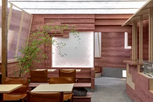 Modern restaurant interior with concrete walls and leather seating