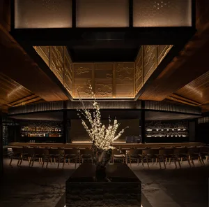 A modern restaurant interior featuring wooden decor and lighting.