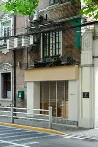 Modern storefront with brick exterior and glass doors.