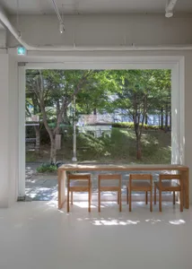 Minimalist interior design featuring wood furniture and large glass window.