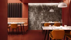 Industrial-themed restaurant interior with marble and concrete finishes.