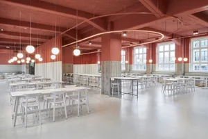 A spacious commercial canteen with modern design elements of concrete and terrazzo
