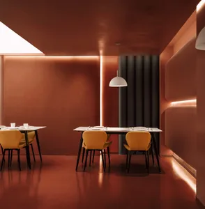 A modern restaurant interior with metal furniture and white pendant lights.