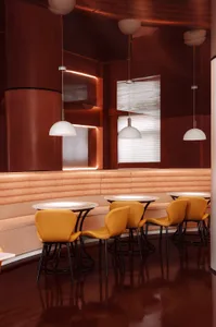 Modern industrial restaurant interior with metallic walls, leather seating, and matte finishes