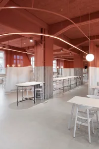 Modern industrial restaurant interior with concrete and brick materials.