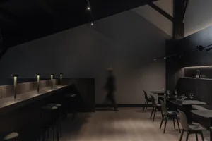 Modern industrial restaurant interior with concrete and wood elements.