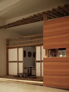A modern lobby features wooden paneling and minimalist design.