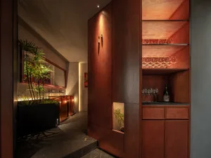 Modern restaurant bar featuring oak cabinets and wooden shelving.