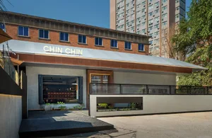 Modern restaurant exterior with concrete and steel structural elements.