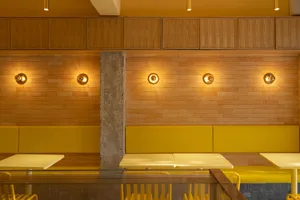 Modern cafe interior with yellow decor and seating