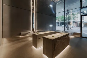 A clean, minimalist retail interior featuring modern design elements and concrete finishes.