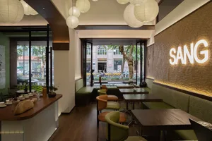 Modern cafe interior with wooden tables and upholstered seating