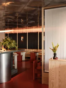 A modern restaurant interior with wooden fixtures and a warm, inviting atmosphere.