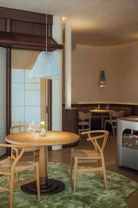 Modern dining room with wood table, fabric chairs, and metal accents.