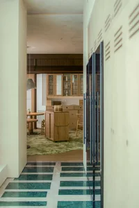 Modern kitchen with wooden cabinets and a green marble floor.