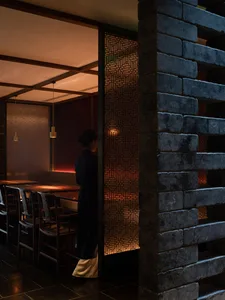 Modern restaurant interior with brick-patterned wall