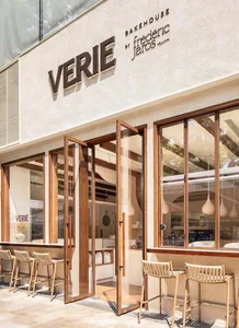 Modern minimalist restaurant exterior with wooden materials and large glass windows