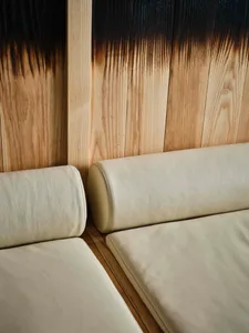 Close-up of minimalist furniture with leather cushions and wooden panels