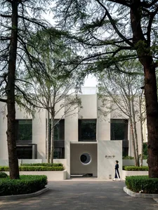 A modern office building with a minimalist design, constructed primarily of concrete materials.