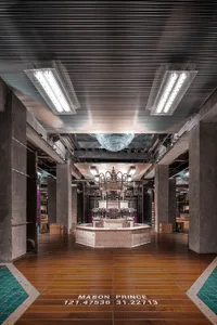 An industrial-style lobby with concrete flooring and a central fountain.