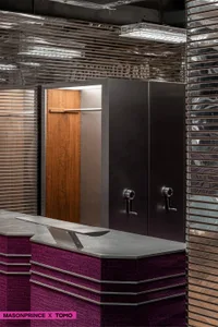 Modern office space with metal clad walls, wooden accents, and floor-to-ceiling windows.
