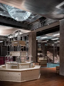 Industrial-style restaurant interior with concrete, glass, and metal elements