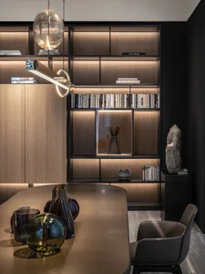 A modern interior with a metal and glass shelf displaying decorative items.