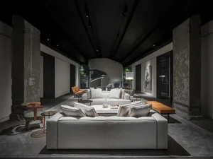 Modern living room with concrete walls and spiral staircase