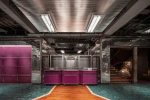 A modern lobby with metal, brick, and concrete elements