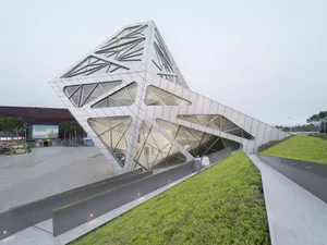 A modern museum with a geometric, metal-clad facade.
