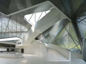 Modern Arabian staircase with glass and concrete elements.