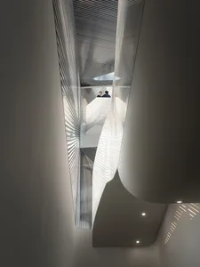 Modern interior featuring a metallic ceiling with geometric patterns.