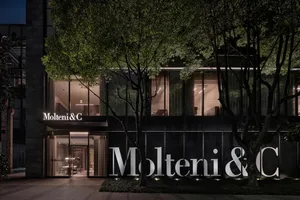 A modern storefront featuring glass windows and black signage.