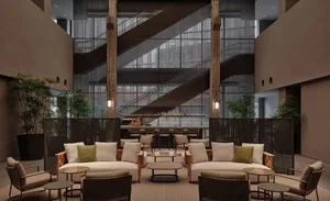 A well-furnished, contemporary living room with neutral-toned furniture and modern decor.