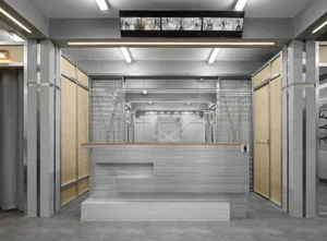 A modern reception desk made from concrete, featuring industrial-style design elements.