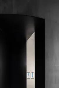 Modern interior with minimalist decor and concrete walls.