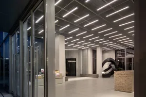 Modern, industrial-style lobby interior with concrete flooring and ceiling.