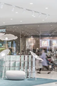 Interior of a modern coffee shop with glass walls.