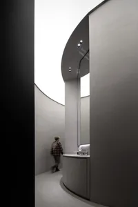 A modern interior design space featuring a minimalist aesthetic and use of concrete materials.