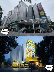 A modern mall exterior with glass and concrete materials, featuring a variety of commercial signs and advertisements.