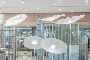 A glass storefront for a retail space with organic, cloud-like shapes.