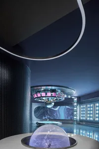 Modern interior design featuring metallic, glass, and plastic materials.