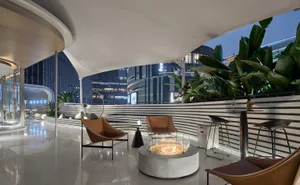 Modern patio with concrete elements and tropical plants for relaxation and aesthetic appeal.