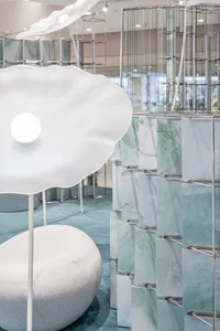 Modern retail shop interior featuring glass, marble, and metal materials