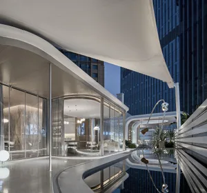 Modern hotel suite featuring sleek glass, concrete, and marble interiors