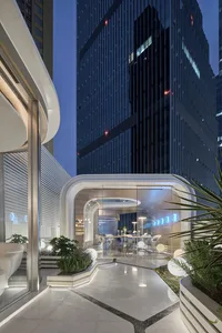 Modern office lobby with glass walls and illuminated circular elements.