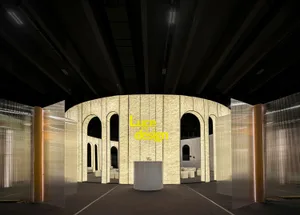 Industrial design exhibition with glass panels and arches.