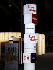 Stacked light boxes with company logos and names displayed at an exhibition.