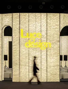 A minimalist retail storefront featuring textured glass panels and a sign that reads 'Luce Design'.