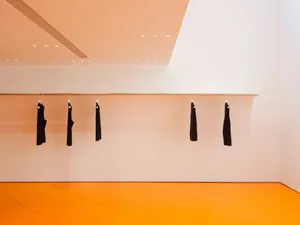 An empty minimalist space with a concrete floor.